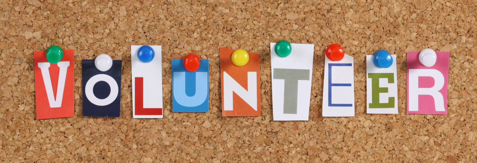 The Word Volunteer On A Cork Notice Board